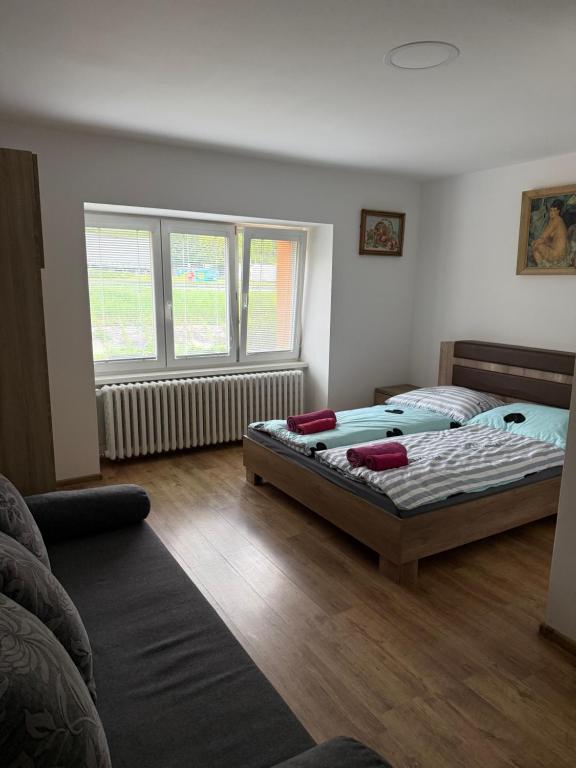 A bed or beds in a room at Ubytovanie Janka