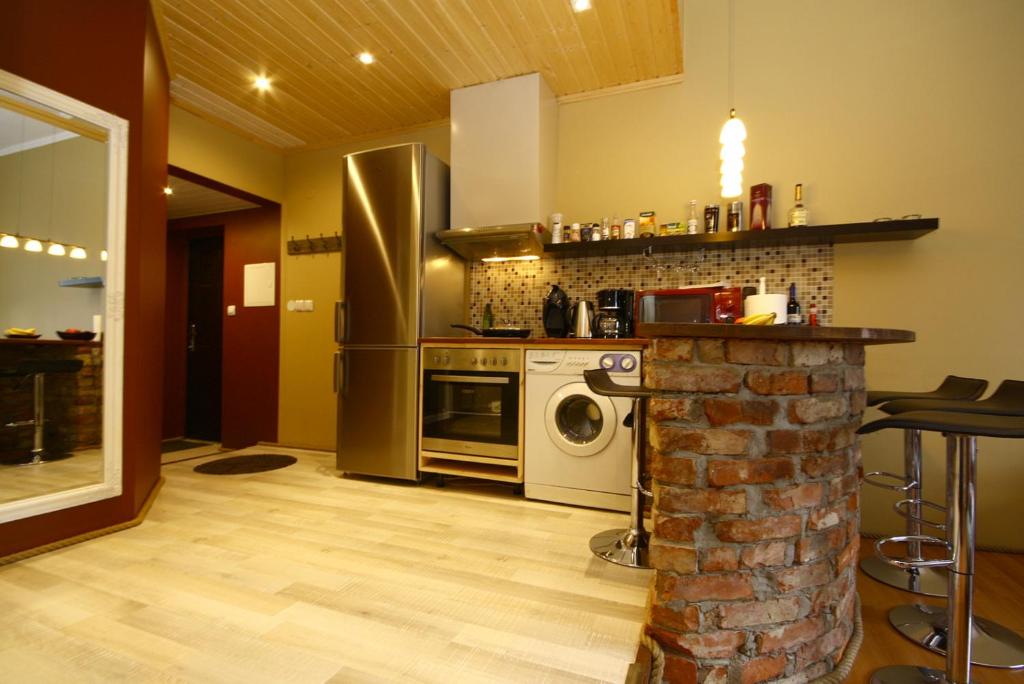 a kitchen with a stove and a washer and dryer at Sadama 11 Apartment in Pärnu