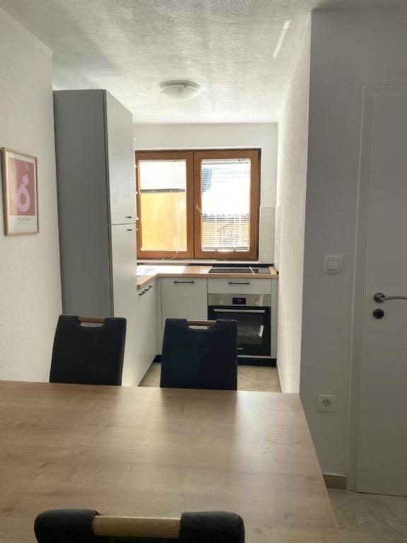 a kitchen with a large wooden table and chairs at Alto Mare Apartments in Selce