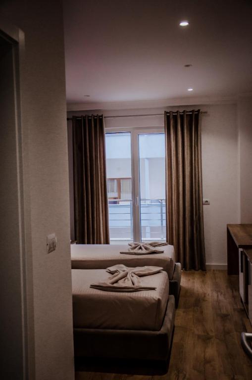 Postel nebo postele na pokoji v ubytování Hotel ERALD