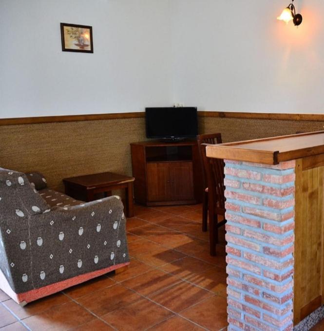 a living room with a couch and a table at Residencial La Teja in Zahora
