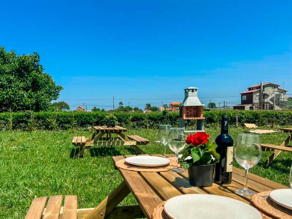a wooden table with glasses and a bottle of wine at La maruca loft deluxe 3000 in Santander