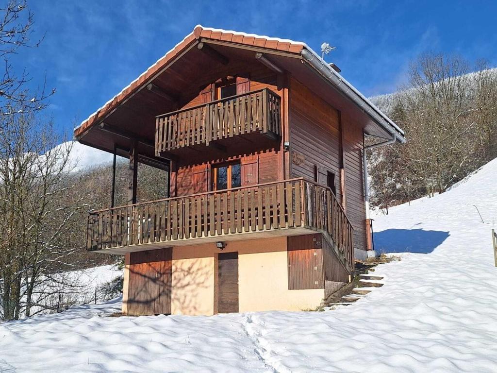Cette cabane en rondins dispose d'un balcon dans la neige. dans l'établissement Le Grenier de Fernand - vue montagne, à Saint-Jean-de-Sixt