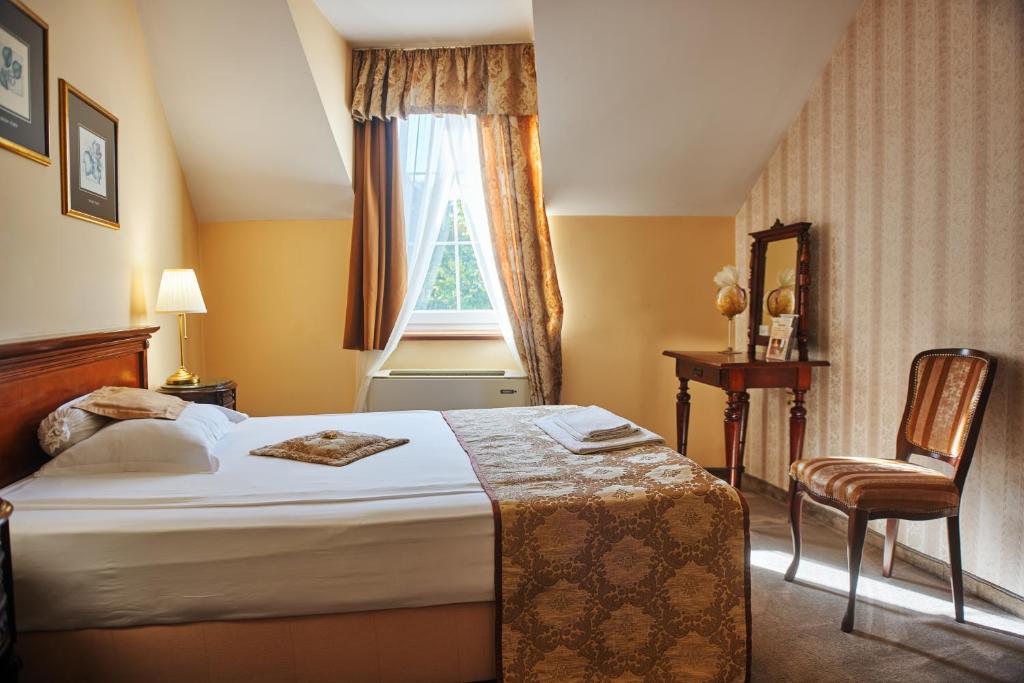 Postel nebo postele na pokoji v ubytování Garni Hotel Andric
