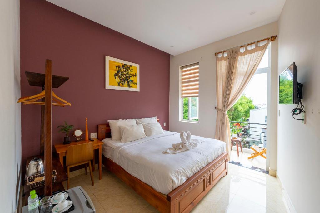 Postel nebo postele na pokoji v ubytování Green Town House Hoi An