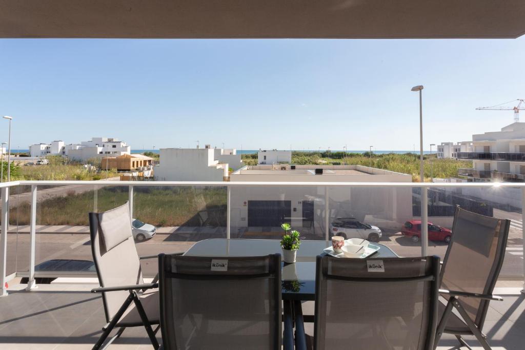 a man sitting at a table on a balcony at AT Gregal II in Oliva