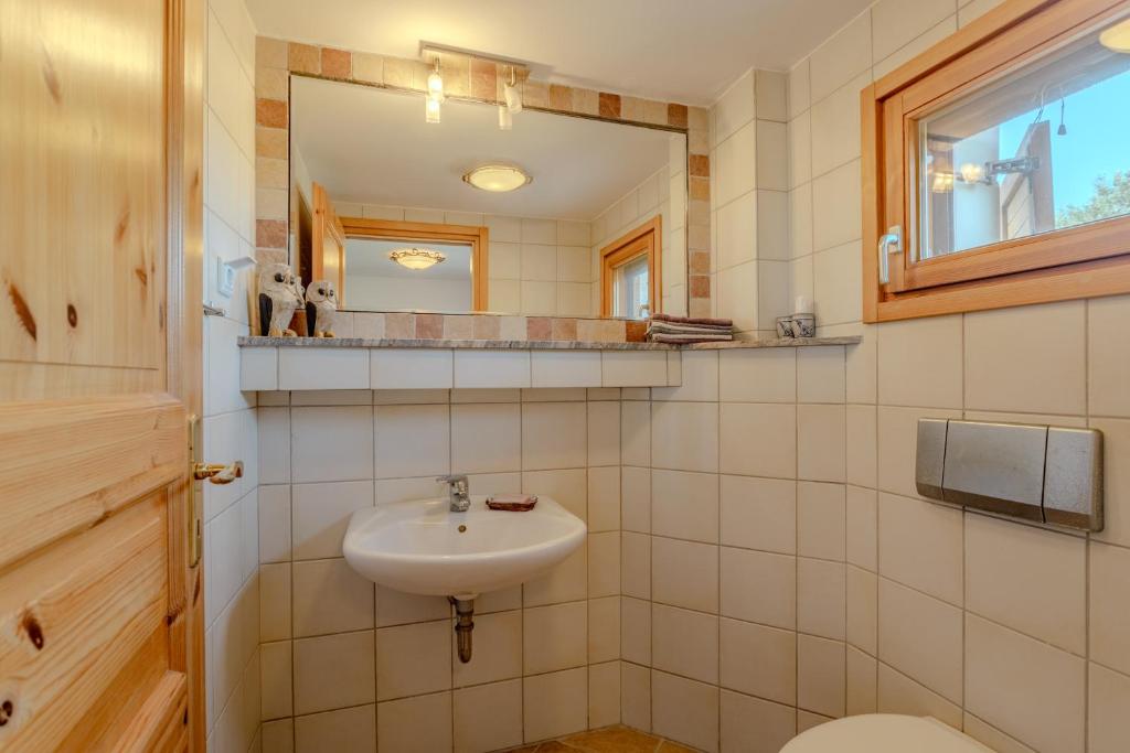 a bathroom with a sink and a mirror at Villa Sternfalle with jacuzzi by 8essentially in Elaía