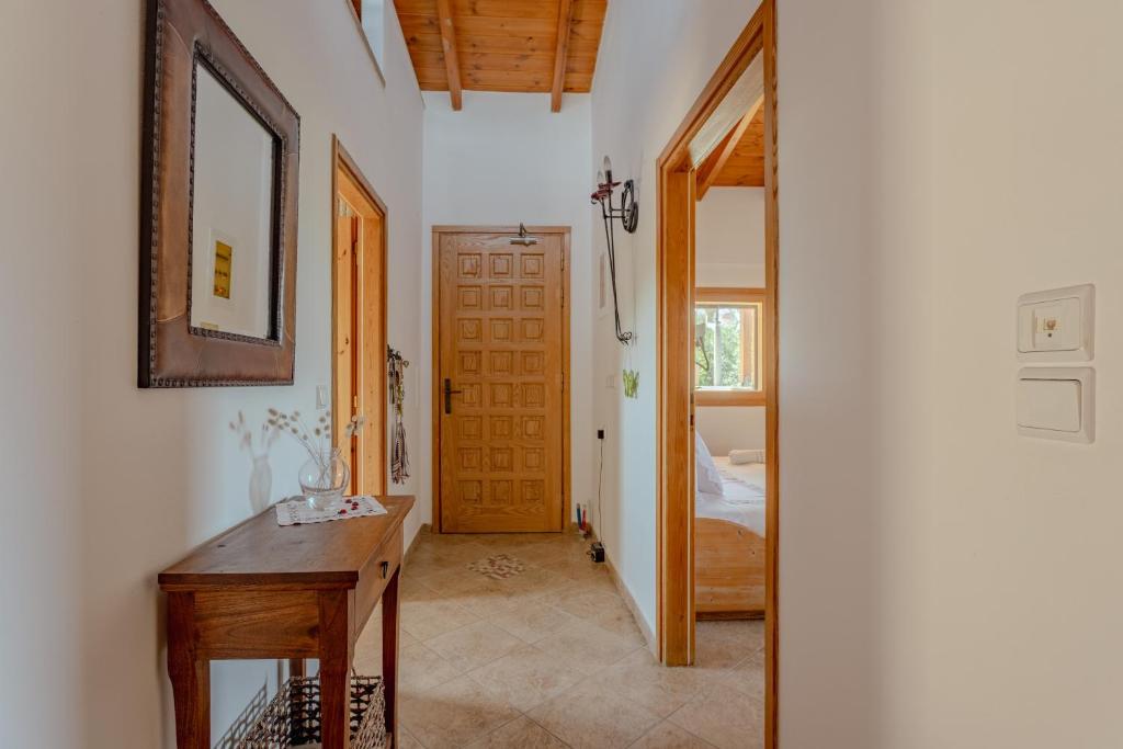 a hallway with a wooden table and a door at Villa Sternfalle with jacuzzi by 8essentially in Elaía