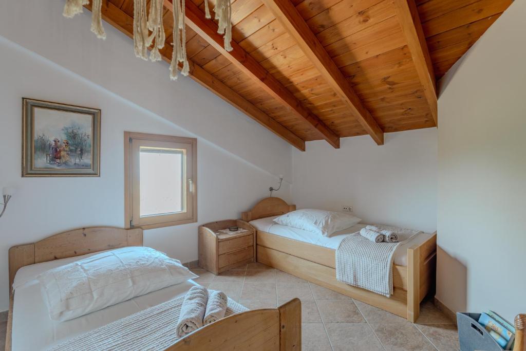 a bedroom with two beds and a window at Villa Sternfalle with jacuzzi by 8essentially in Elaía