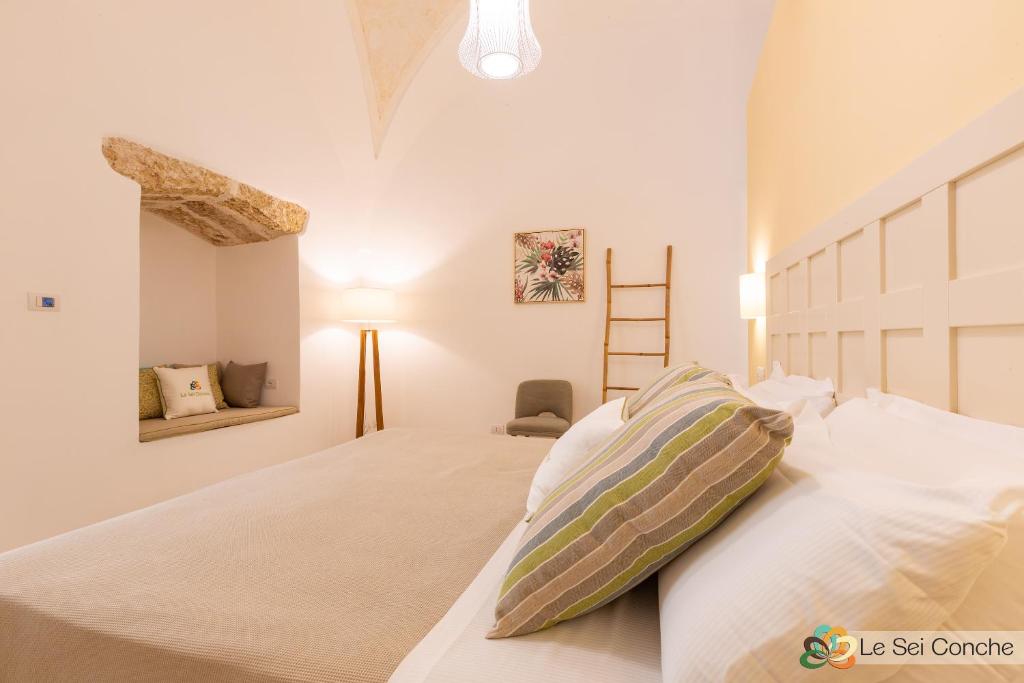 Łóżko lub łóżka w pokoju w obiekcie Le Sei Conche Relais & SPA