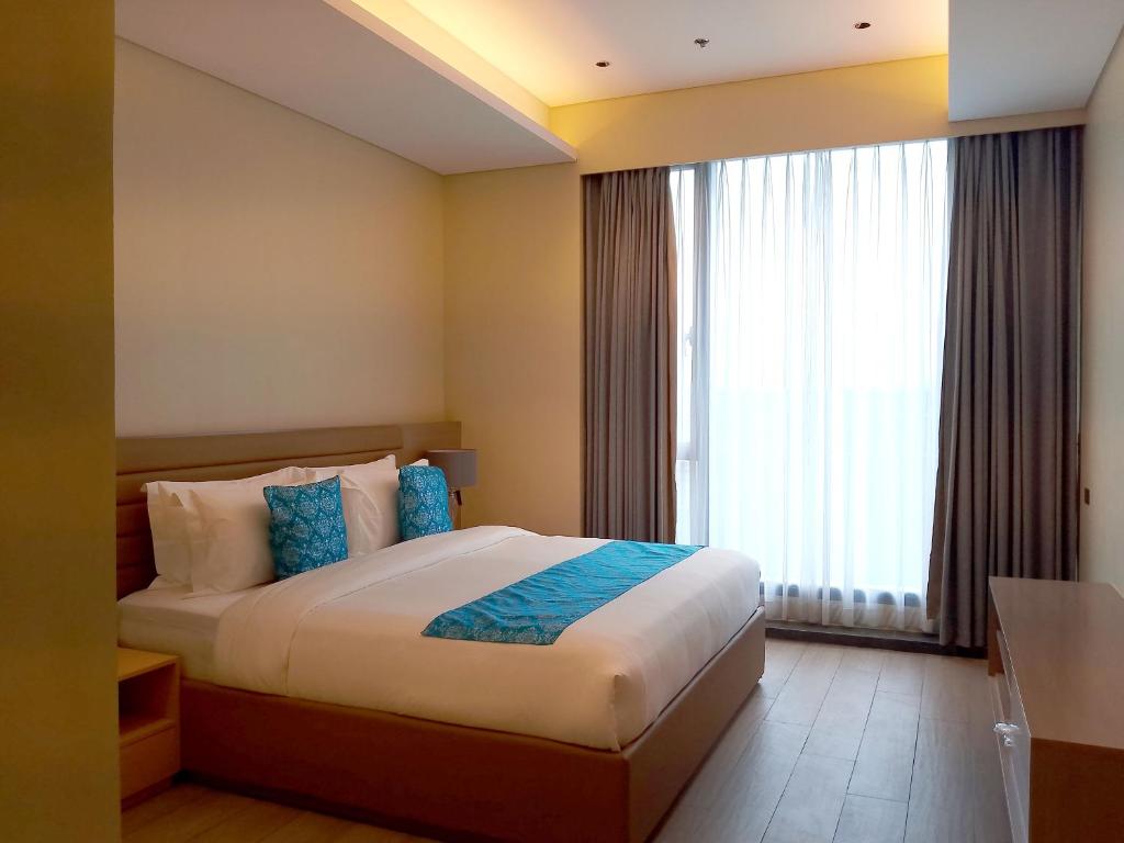 Postel nebo postele na pokoji v ubytování Bayprime Hotel