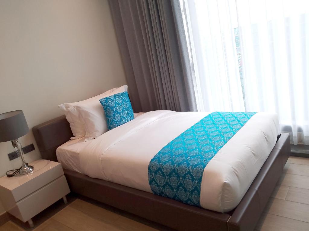 Postel nebo postele na pokoji v ubytování Bayprime Hotel