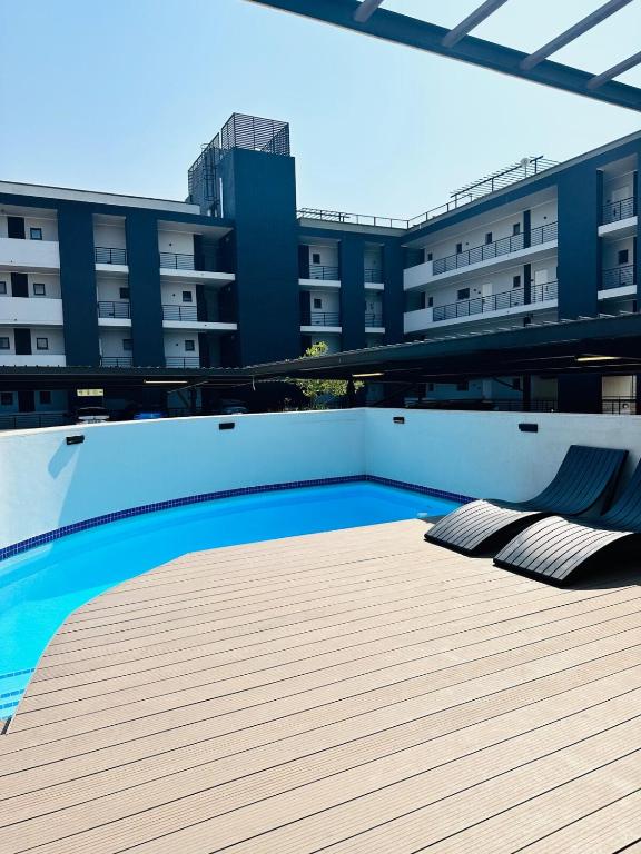 a swimming pool on the roof of a building at Next to Brooklyn Mall Cosy stay in Pretoria