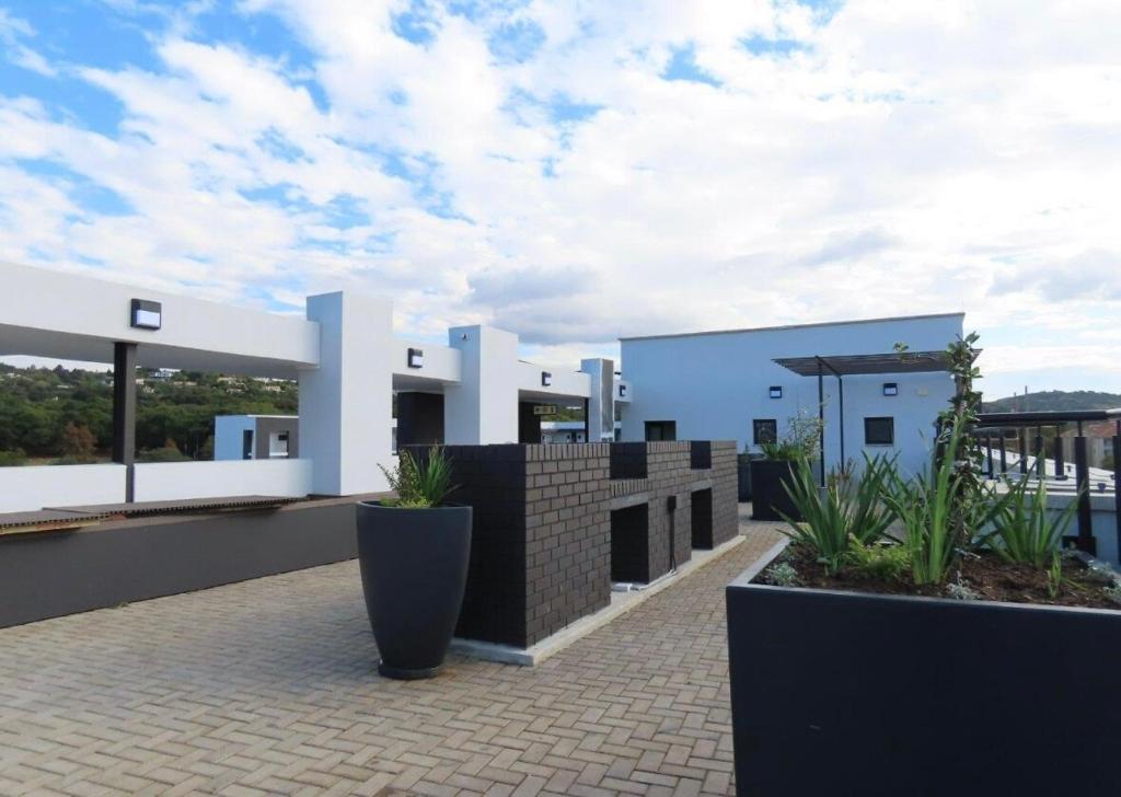 a house with some plants on the roof at Next to Brooklyn Mall Cosy stay in Pretoria