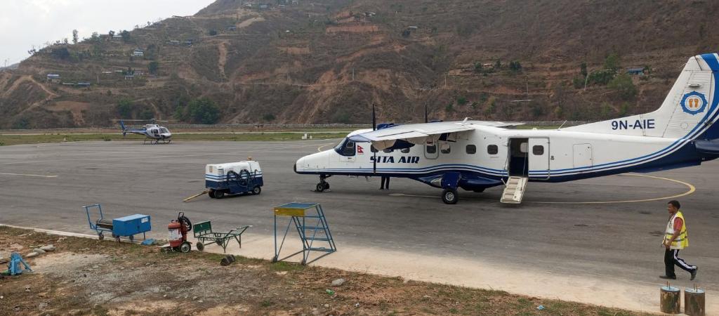 un piccolo aereo è parcheggiato su una pista di Anil Guest house and khajaghar a Rāmechhāp