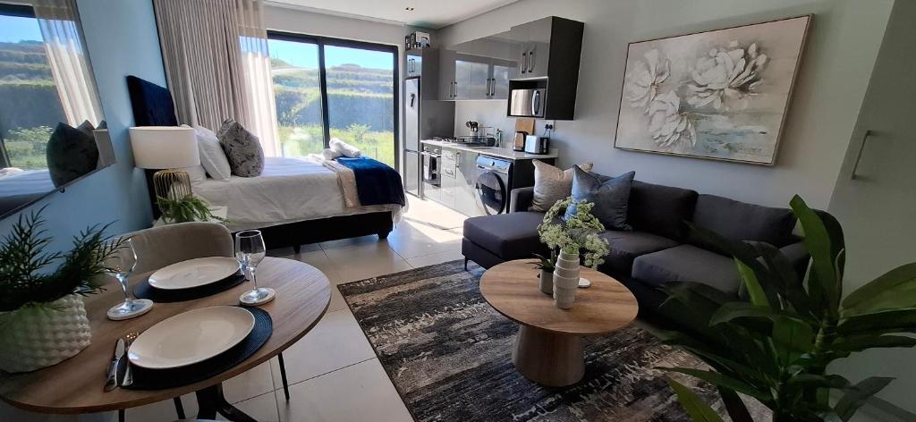 a living room with a couch and a table at Ocean Club Zimbali Lakes D16 in Ballito