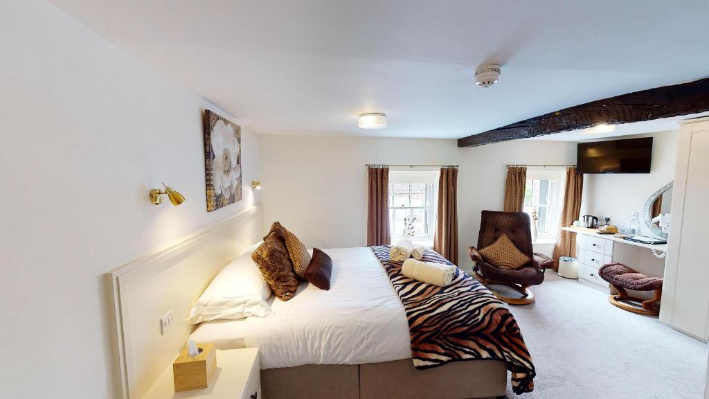a bedroom with a bed with a zebra blanket at Black Swan in Penrith