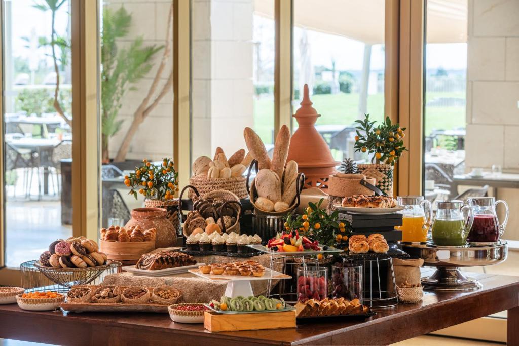a buffet of bread and pastries on a table at Victoria Golf Resort and Spa Managed by Accor in Vilamoura