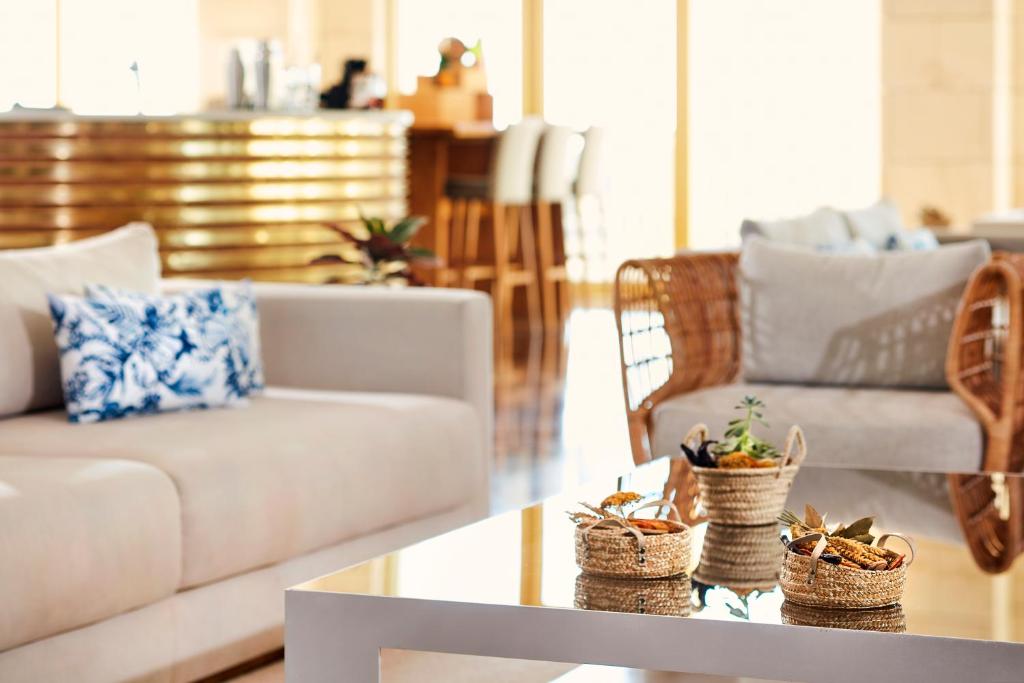 a living room with a couch and a table at Victoria Golf Resort and Spa Managed by Accor in Vilamoura