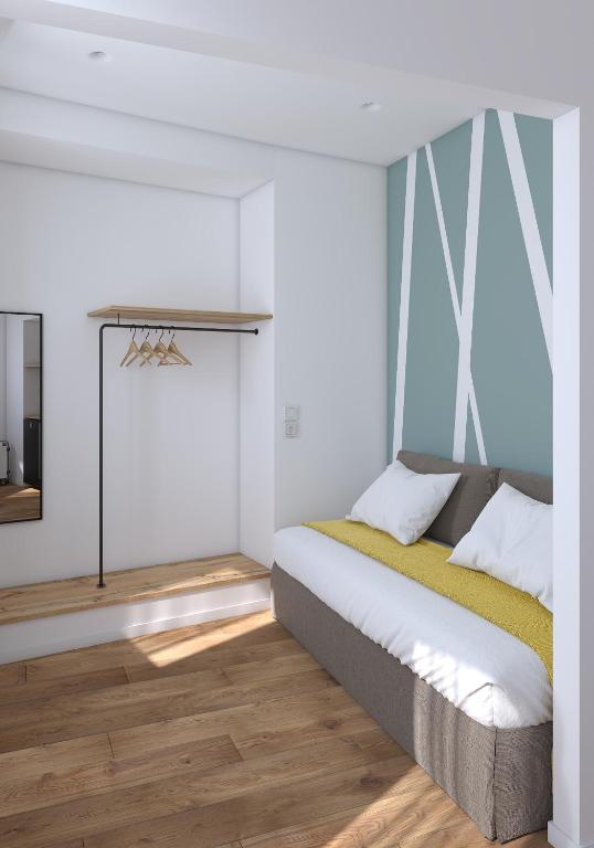 a bedroom with a bed and a mirror at Lᾶs Serifos in Livadi