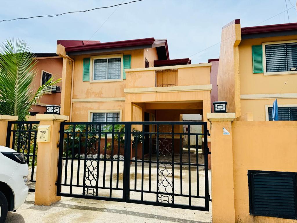 a house with a gate in front of it at Santiago City Transient House in Santiago