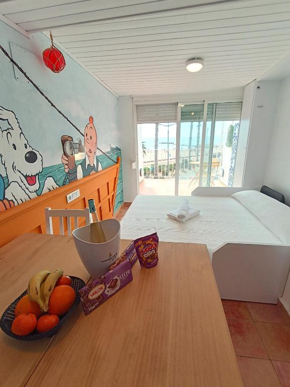 a bedroom with a table with a bowl of fruit on it at Cencibel - Harbor's Light in Villajoyosa