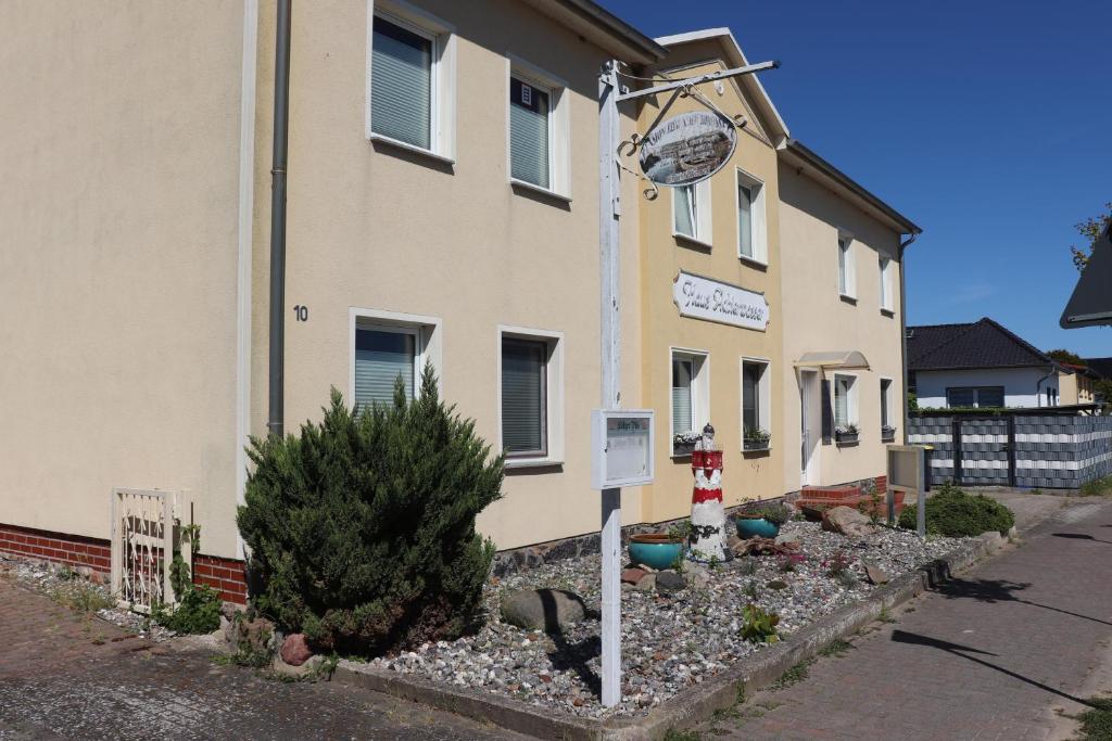 a building with a clock on the side of it at Möwennest Zempin in Zempin