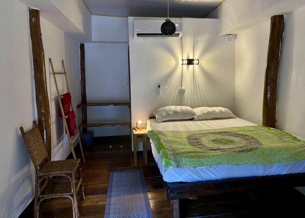 a bedroom with a bed and a table and a chair at Soundgarden Kohrong in Koh Rong