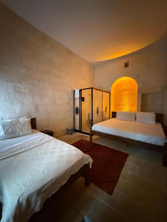 Ένα ή περισσότερα κρεβάτια σε δωμάτιο στο Taştepeler Konak