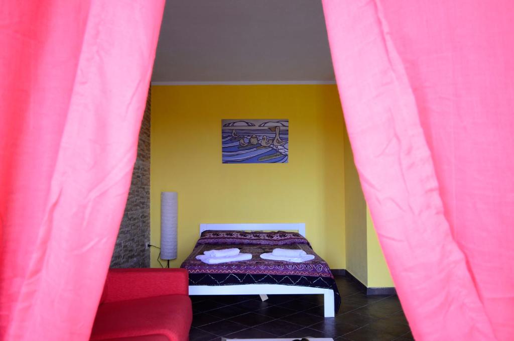 Postel nebo postele na pokoji v ubytování Residenze L'Isola Surf House