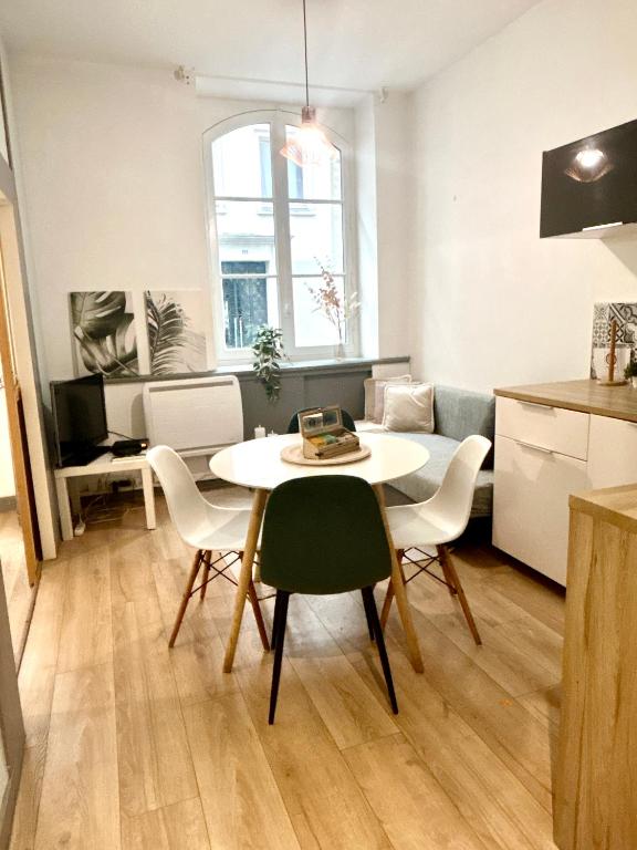 une cuisine et une salle à manger avec une table et des chaises dans l'établissement Au Coeur de Nantes - idealement situé Studio tout confort avec chambre separée, à Nantes
