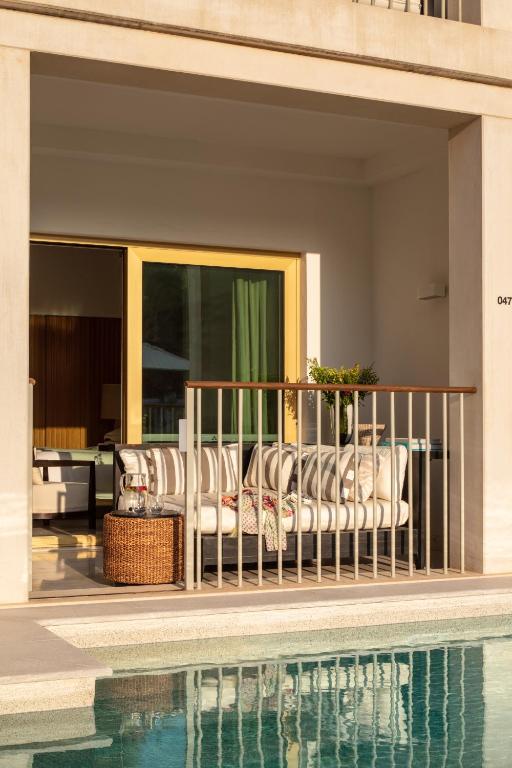 a group of chairs sitting on a balcony next to a swimming pool at Victoria Golf Resort and Spa Managed by Accor in Vilamoura