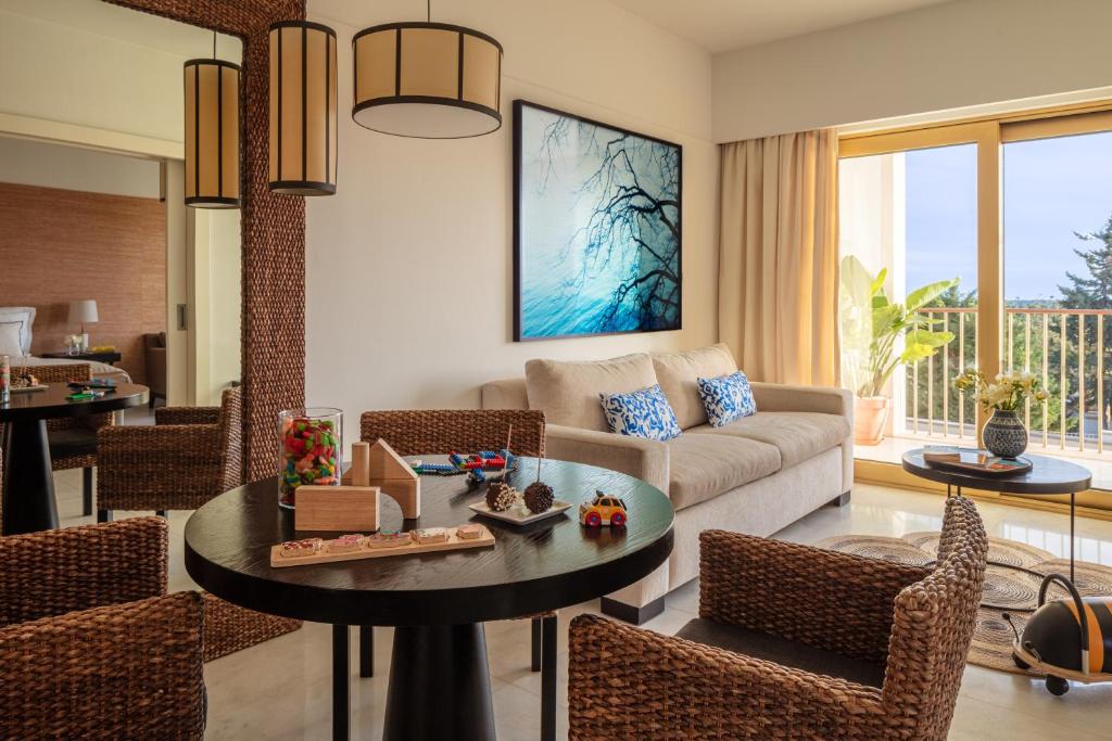 a living room with a couch and a table at Victoria Golf Resort and Spa Managed by Accor in Vilamoura