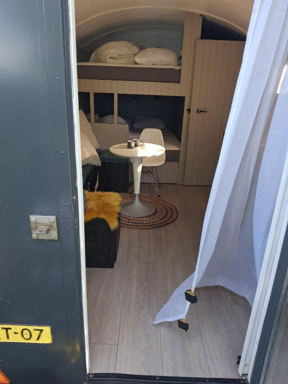 a room with a bed and a table and a room with a tableablishangering at De Zonnewagen in Sint Jacobiparochie
