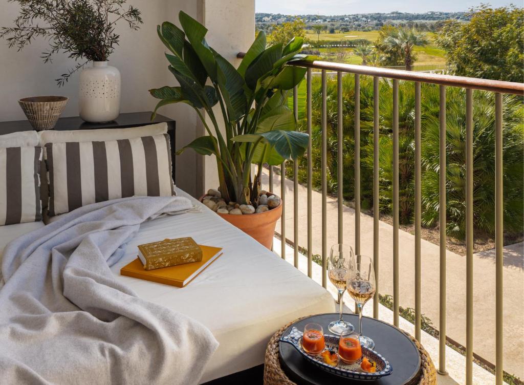 a balcony with a table with glasses of orange juice at Victoria Golf Resort and Spa Managed by Accor in Vilamoura