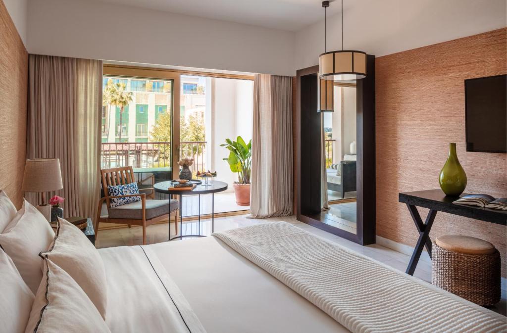 a bedroom with a bed and a living room at Victoria Golf Resort and Spa Managed by Accor in Vilamoura