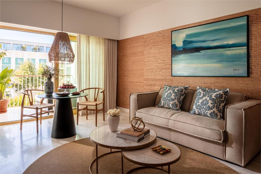 a living room with a couch and a table at Victoria Golf Resort and Spa Managed by Accor in Vilamoura