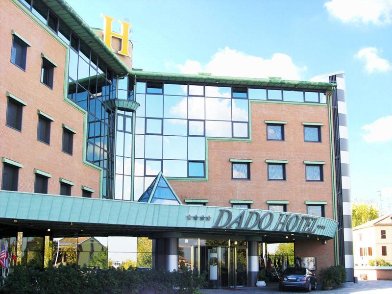 a large building with a sign in front of it at Dado Hotel International in Parma
