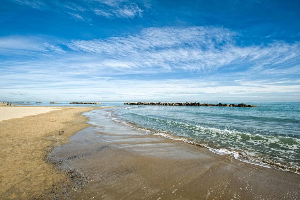 una spiaggia sabbiosa con molo in acqua di Villa Elena a Montesilvano