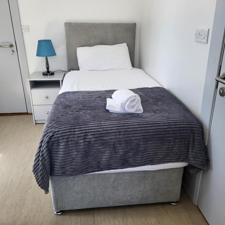 una camera da letto con un letto e un asciugamano sopra di Trivia House a Swanlinbar