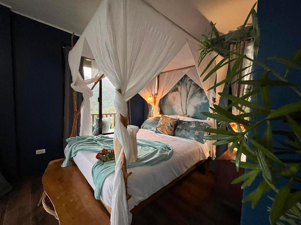 a bedroom with a bed with a canopy at Romantic Eco Sanctuary Off-Grid Mountain Retreat in Valencia