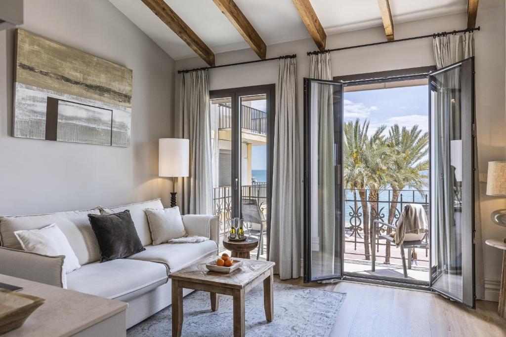 a living room with a white couch and a view of the ocean at Velamar in Aduanas