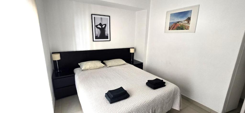 a bedroom with a bed with two black bags on it at Historic Centre A - Albufeira in Albufeira