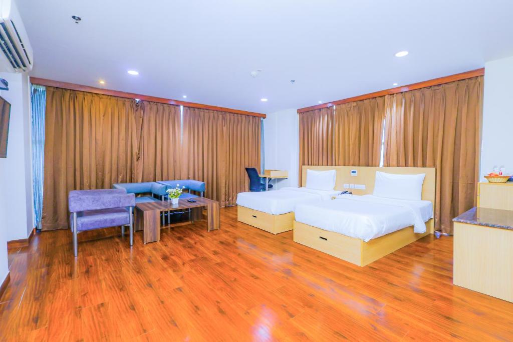Postel nebo postele na pokoji v ubytování Hyphen Business Hotel