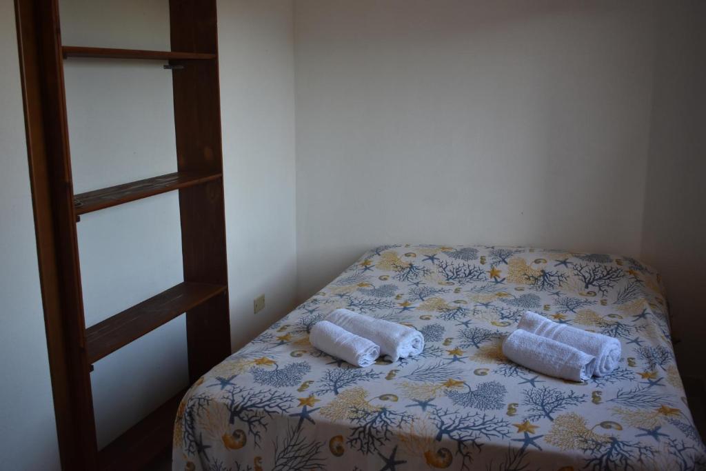 A bed or beds in a room at Appartamenti San Teodoro