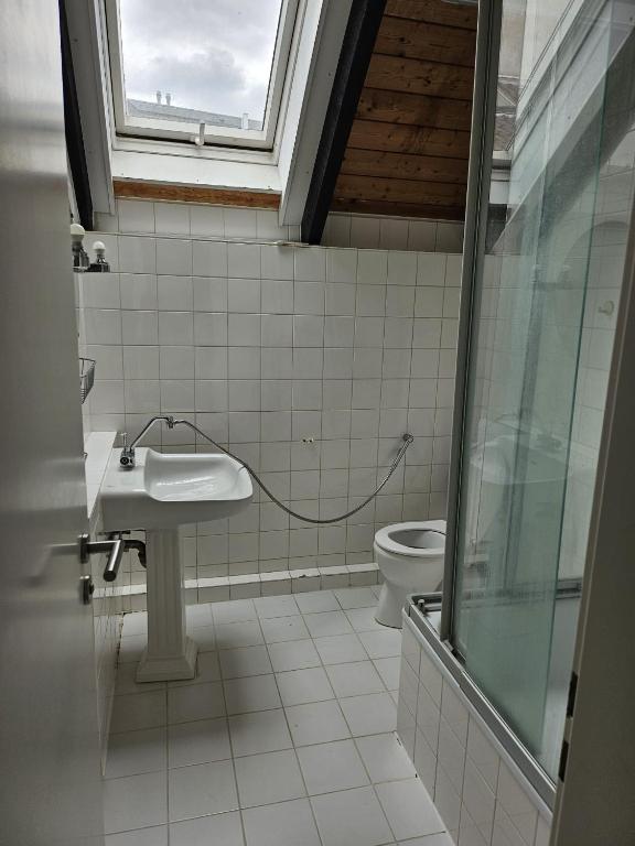 a bathroom with a sink and a toilet at Paradies 1 in Bonn