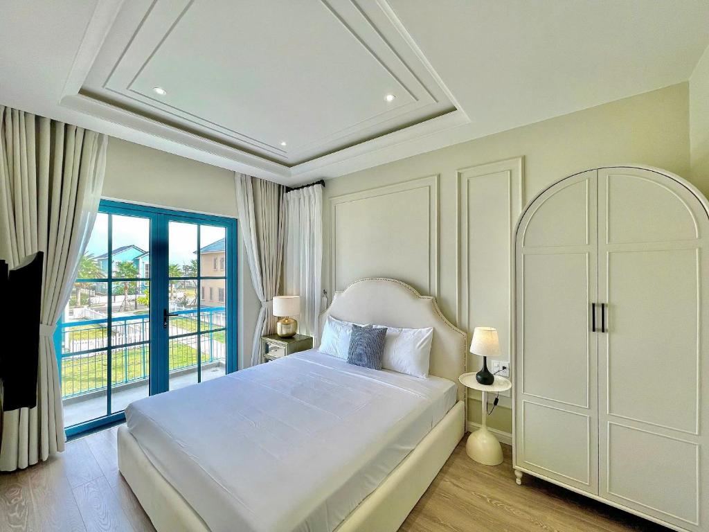 Postel nebo postele na pokoji v ubytování Novaworld Phan Thiết