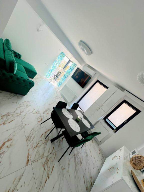 an overhead view of a living room with a table and chairs at Mall Residence in Văleni