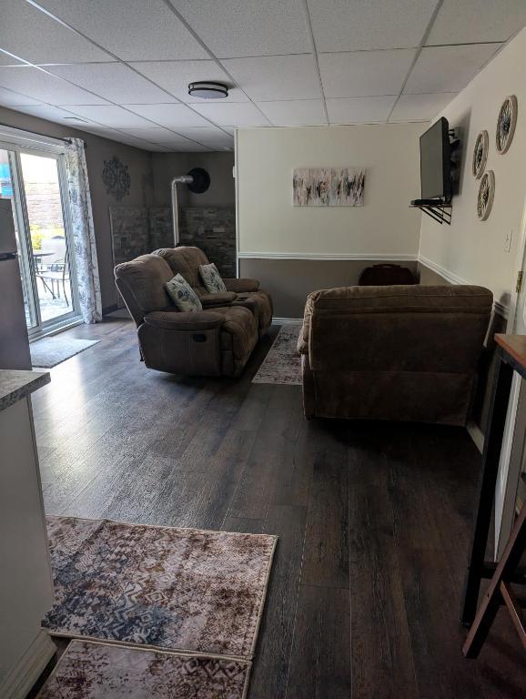a living room with two chairs and a couch at Suite in the Bush-Private Apartment in Bancroft