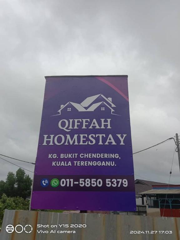 a sign for an open home warranty on a building at Qiffah Homestay in Kuala Terengganu